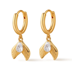 Macro detail of gold-plated mermaid tail earring featuring a pear-cut cubic zirconia stone