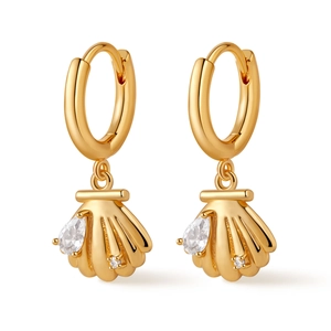Macro detail of gold-plated seashell hoop earring featuring sparkling drop-cut zircon