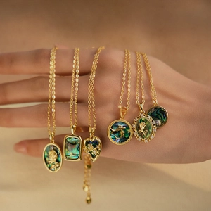 Gold abalone shell necklaces featuring heart and oval floral pendants for women