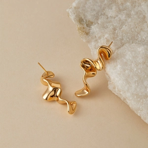 Modern gold irregular wave earrings with a liquid metal texture and polished finish