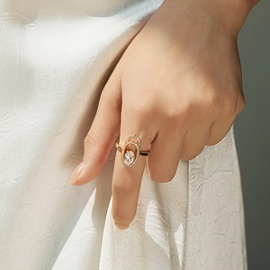 Detailed view of bohemian gold ring featuring an oval zircon with double pave halos