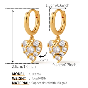 Close-up of heart charm hoop earrings with zircons and 18k gold plated finish details