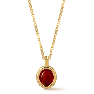 Close-up of vintage gold necklace with round red carnelian stone pendant