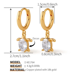 Detailed view of turtle-shaped gold earrings with dimensions 27mm by 15mm and zircon inlay