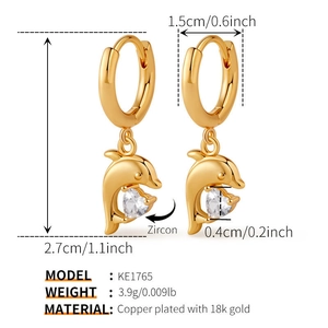 Detail view of 18K gold-plated dolphin hoop earrings with sparkling heart zircon stones