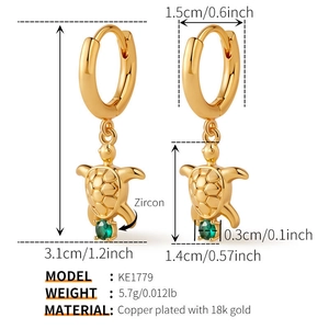 Detail view of 18k gold plated turtle hoop earrings with green zircon stones