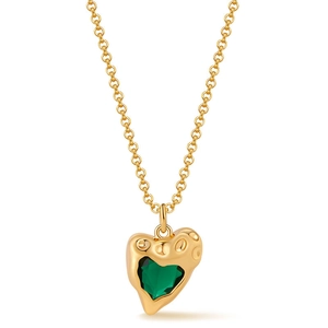 Macro detail of gold-plated chain with an irregular heart-shaped green zircon pendant