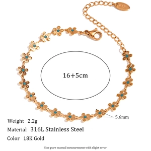 Detail of 18K gold plated stainless steel bracelet with blue enamel flower charms