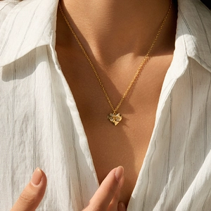 18K gold plated heart necklace with zircon cross star pendant on a female model