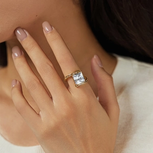 Close-up of gold 18K starfish ring with a square zircon in a unique staggered setting
