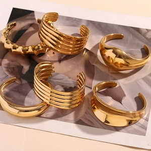 Detailed view of layered 18K gold plated stainless steel bangles with ribbed texture