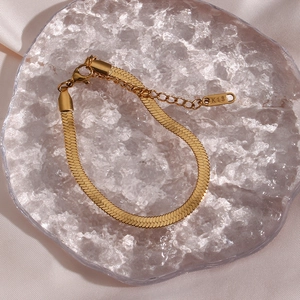 Close-up of gold snake chain bracelet with K18 engraving and lobster clasp