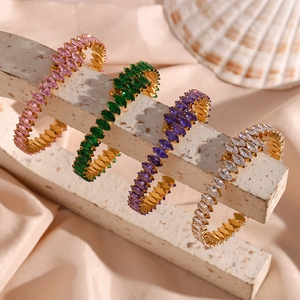 Detailed view of four colorful marquise-cut zircon bracelets on a gold-plated base
