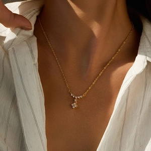Close-up of 18K gold plated butterfly pendant necklace with sparkling diamonds on model