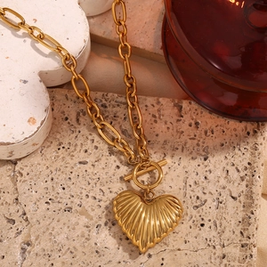 Detail of 18K gold-plated heart pendant with textured ridges and elegant OT toggle clasp