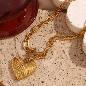 Detail of 18K gold-plated irregular link chain with heart pendant and OT toggle clasp