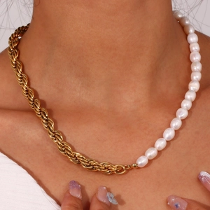 Close-up of pearl and gold rope chain necklace on neck showing elegant texture