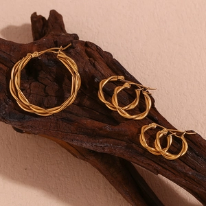Three pairs of twisted rope hoop earrings in 18K gold plated stainless steel on wood