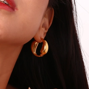 Polished 18K gold plated stainless steel teardrop hoop earrings for women shown on model