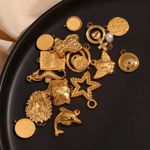 Detail of 18K gold plated stainless steel charms featuring starfish and geometric patterns