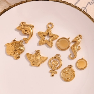 Detailed macro view of 18K gold plated stainless steel starfish and animal pendants