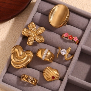 Detailed collection of 18K gold plated stainless steel rings in a grey velvet jewelry box