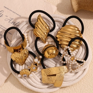 Close-up of assorted 18K gold plated metal hair ties with vintage butterfly and heart charms