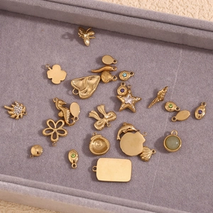 Macro shot of 14K gold plated stainless steel charms including bee and star motifs