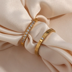 Elegant 18K gold plated stainless steel ring set with zircon accents on beige silk