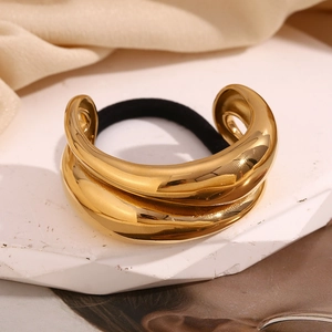 Detail of 18K gold-plated double-layer water drop hair tie with polished metal finish