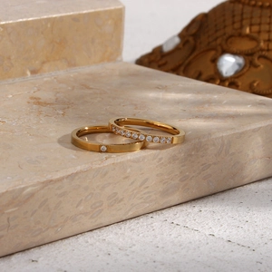 Detail of 18K gold plated stainless steel ring set with zircon on natural stone