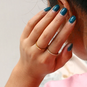 Close-up of dual 18K gold-plated stainless steel rings with zircon stacking details