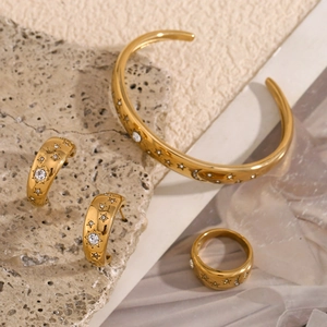 Detailed view of 18K gold plated celestial jewelry set with star and moon engravings