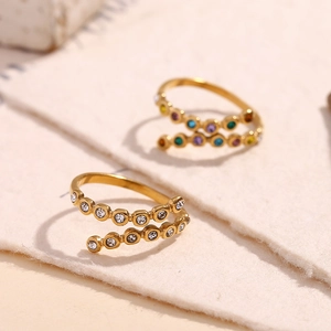 Detail of 18K gold plated spiral rings with multi-color and white cubic zirconia crystals