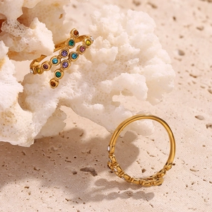 Macro detail of 18K gold plated crisscross ring featuring multi-color micro-pave crystals