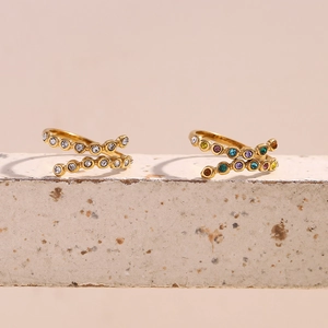 Detailed macro of 18K gold plated spiral rings with vibrant multi-colored zirconia stones