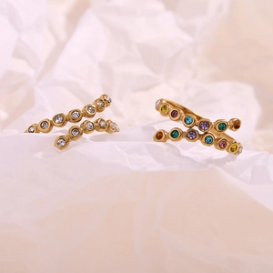 Detail of 18K gold plated crossover rings with multi-color and white cubic zirconia