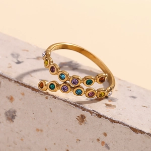 Detailed close-up of 18K gold-plated crossover ring featuring multi-color micro-inlaid stones