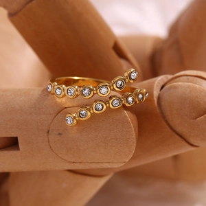 Detail of 18K gold-plated criss-cross open ring with micro-pave sparkling crystals