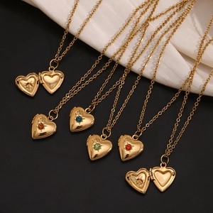 Detail of 18K gold plated heart locket necklaces with colorful birthstones on black silk