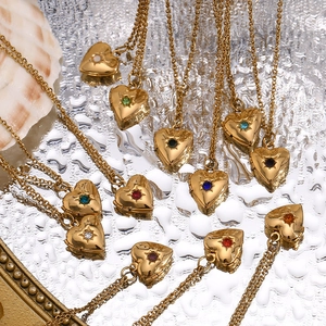 Macro shot of 18K gold plated heart locket necklaces with colorful birthstones on silver