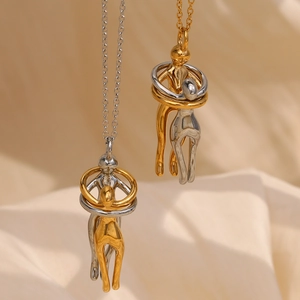 Macro detail of abstract lovers embrace pendant necklace in 18K gold and silver plating