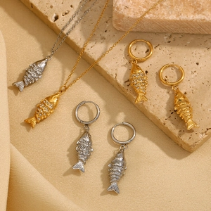 Elegant 18K gold and silver koi fish jewelry set with sparkling rhinestones on stone base