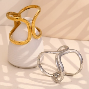 Sleek geometric metal hair claws in gold and silver finish with elegant tree shadow