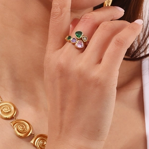 Close-up of 18K gold plated heart-shaped multi-color zircon ring worn by a model