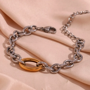 Detailed macro view of two-tone chunky cuban chain bracelet in 18K gold and silver steel