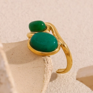 Detailed macro of 18K gold plated stainless steel ring featuring two green oval stones