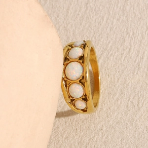 Close-up of 18K gold plated stainless steel ring set with five opal stones