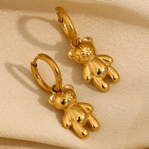 Polished 18K gold plated stainless steel teddy bear hoop earrings on silk background