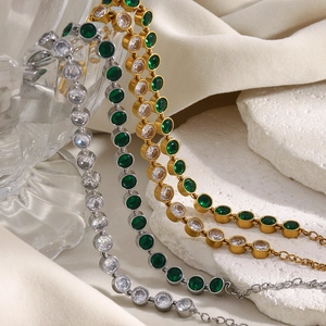 Detailed view of 18K gold plated tennis bracelets with sparkling green and clear zircons